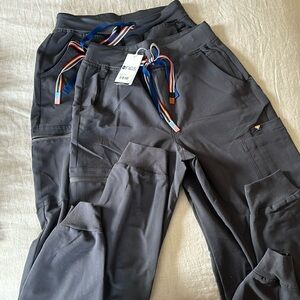 2 pairs of Figs Women’s Zamola Jogger Scrub Pants. Charcoal color. Size small.